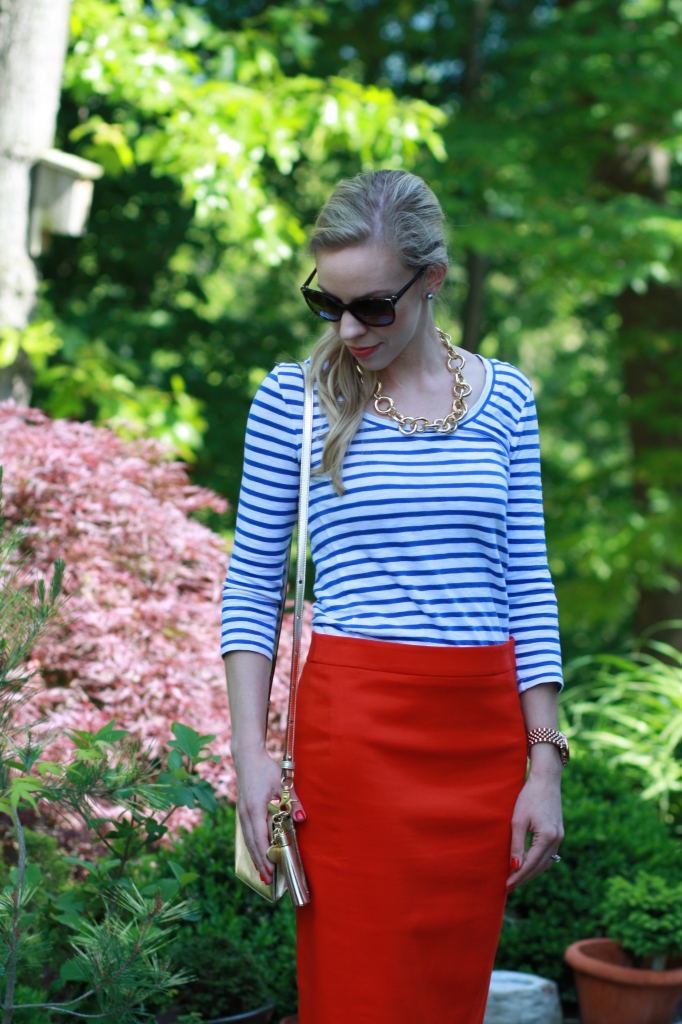 blue striped boatneck tee, gold chain link chunky necklace, Prada sunglasses, bright red pencil skirt