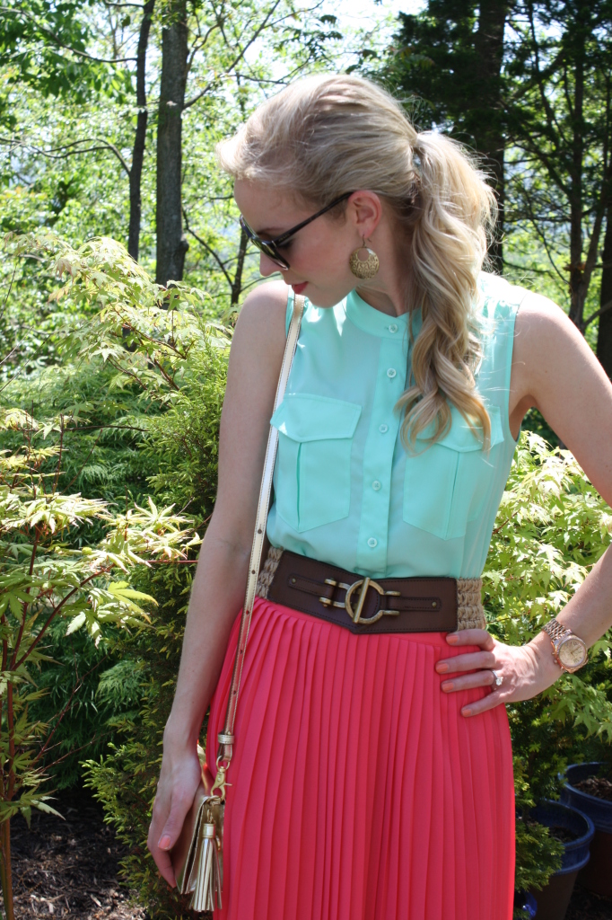 sleeveless mint blouse, wide brown and gold waist belt, coral pleated skirt, gold Brahmin Amelia crossbody bag