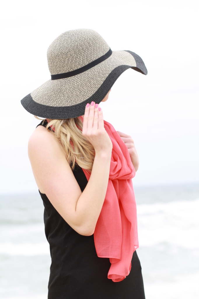 oversized black floppy straw hat, coral scarf, black maxi dress, coral nails