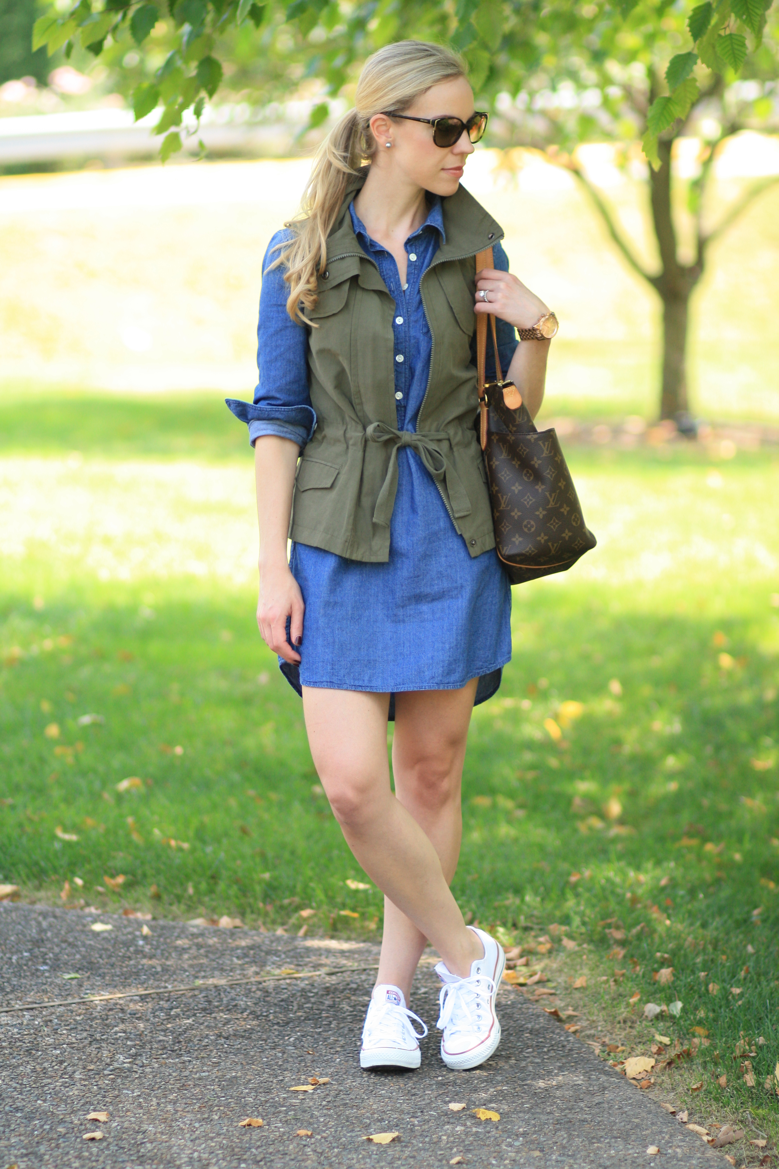 J. Crew chambray denim dress, utility vest, olive green, popped collar,  vest over denim dress, white Converse classic sneakers, Prada sunglasses,  Louis Vuitton large tote. weekend casual look, denim and olive 