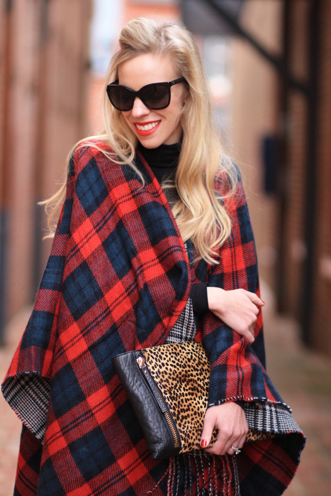 red plaid reversible ruana poncho, how to wear a ruana poncho, oversized leopard clutch, Chanel black cateye sunglasses, clinique red red red lipstick, holiday plaid outfit