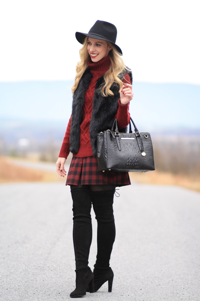 black wool fedora, burgundy chunky knit turtleneck with fur vest, TopShop black gilet vest, Brahmin black small lincoln satchel, Stuart Weitzman black Highland thigh high boots, plaid mini skirt, winter outfit