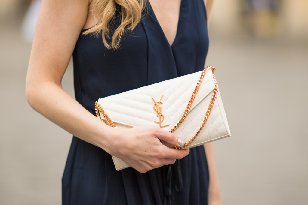 H&M navy blue jumpsuit, Saint Laurent white chain wallet handbag, YSL white envelope  clutch, halter jumpsuit outfit - Meagan's Moda