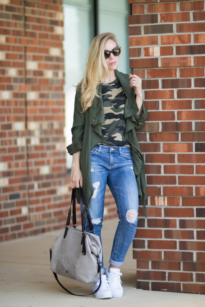 J. Crew olive green utility jacket worn over open denim shirt and