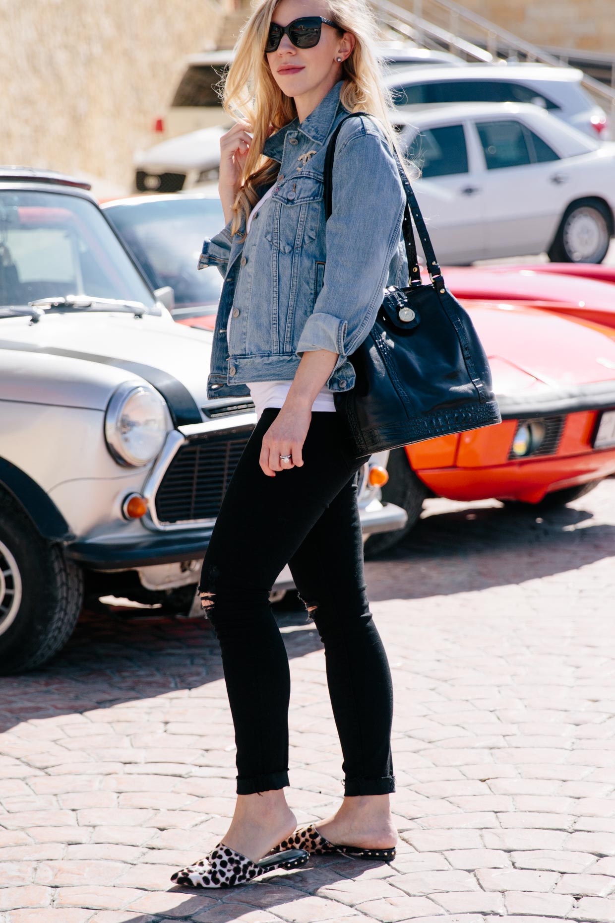 Meagan Brandon fashion blogger of Meagan's Moda wears an oversized black  blazer with leopard print tee, high waist denim shorts and white sneakers  for casual chic blazer outfit - Meagan's Moda