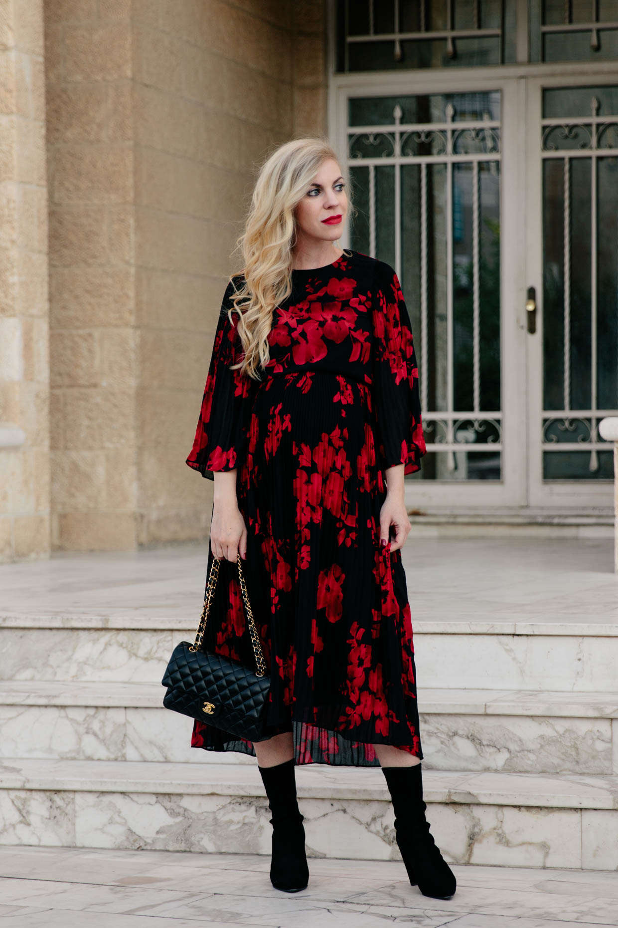 https://meagansmoda.com/wp-content/uploads/2017/10/Meagan-Brandon-fashion-blogger-wears-red-and-black-floral-midi-dress-for-fall-with-sock-boots-for-chic-maternity-outfit.jpg