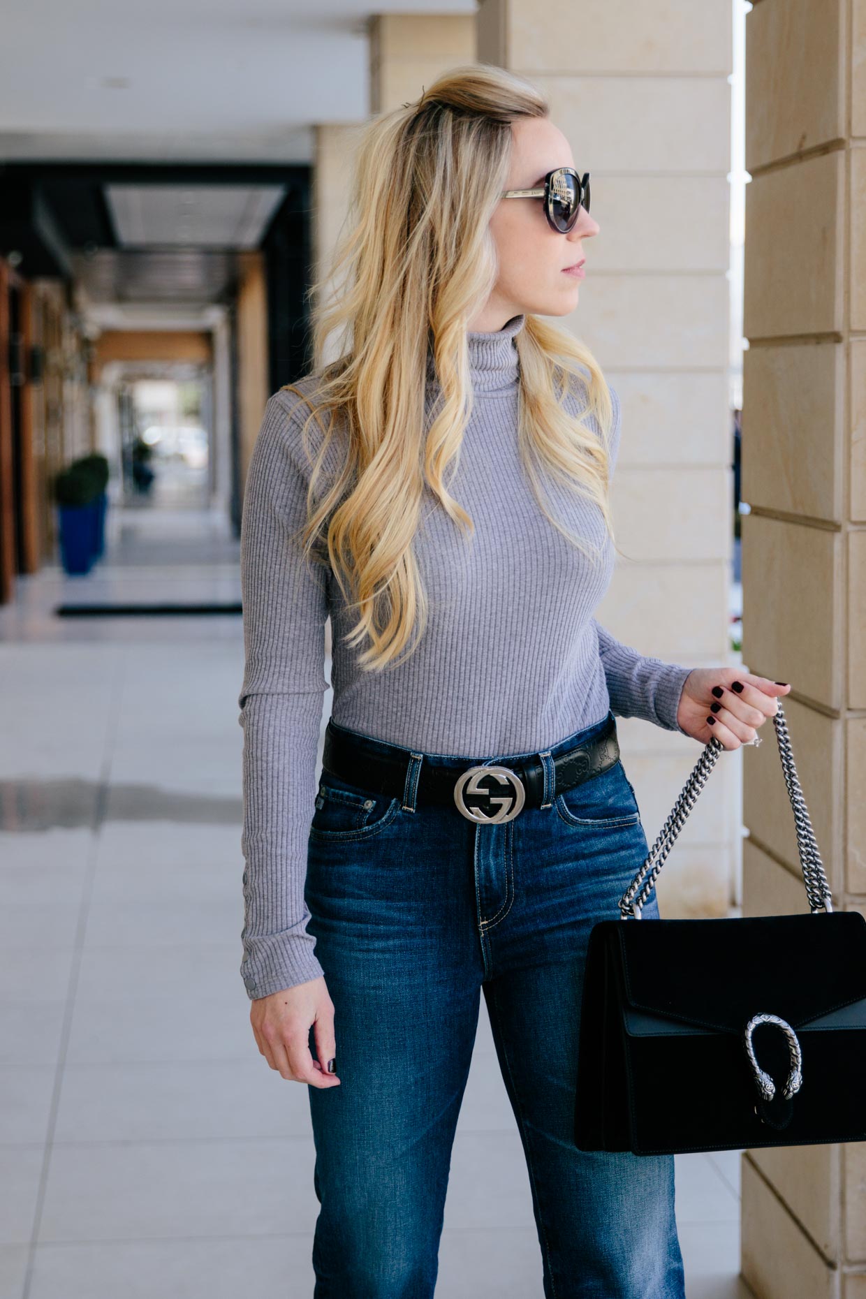 Meagan Brandon fashion blogger of Meagan's Moda wears gray turtleneck  bodysuit with AG Rhett high waist jeans and black Gucci logo belt - Meagan's  Moda