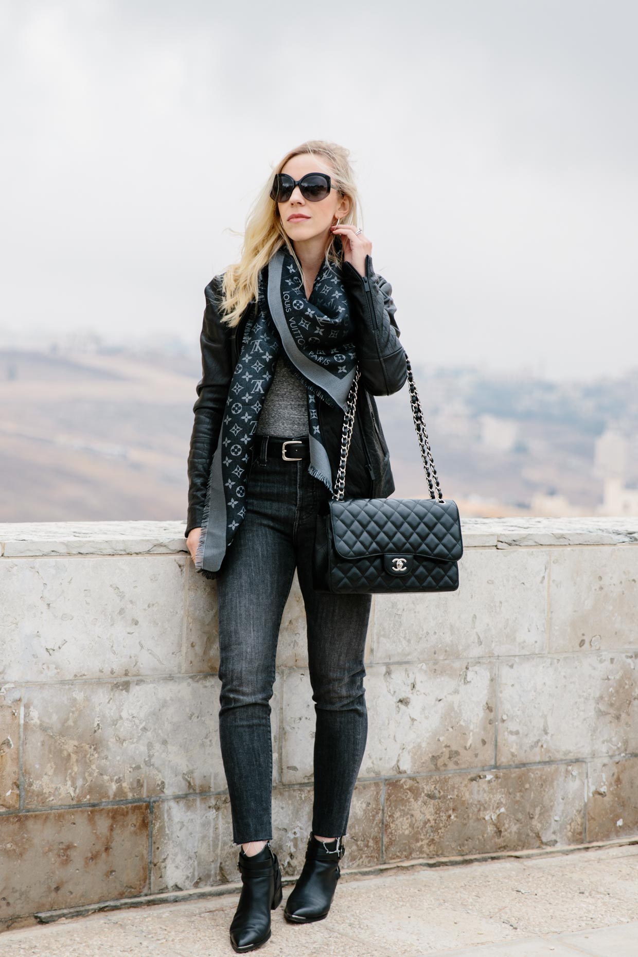 Elegant lady with hat, scarf, boots and Louis Vuitton bag