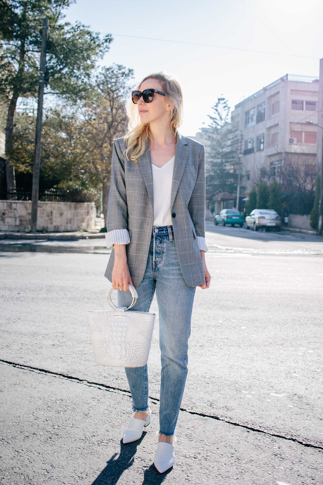 Meagan Brandon fashion blogger of Meagan s Moda styles gray pinstripe blazer with straight leg jeans and white mules for chic outfit with blazer and denim Meagan s Moda