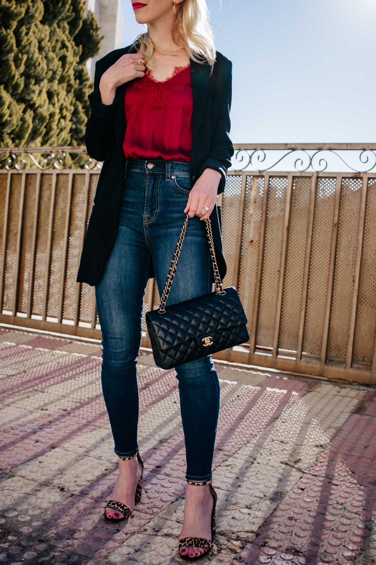 Meagan Brandon fashion blogger of Meagan's Moda wears an oversized black  blazer with leopard print tee, high waist denim shorts and white sneakers  for casual chic blazer outfit - Meagan's Moda