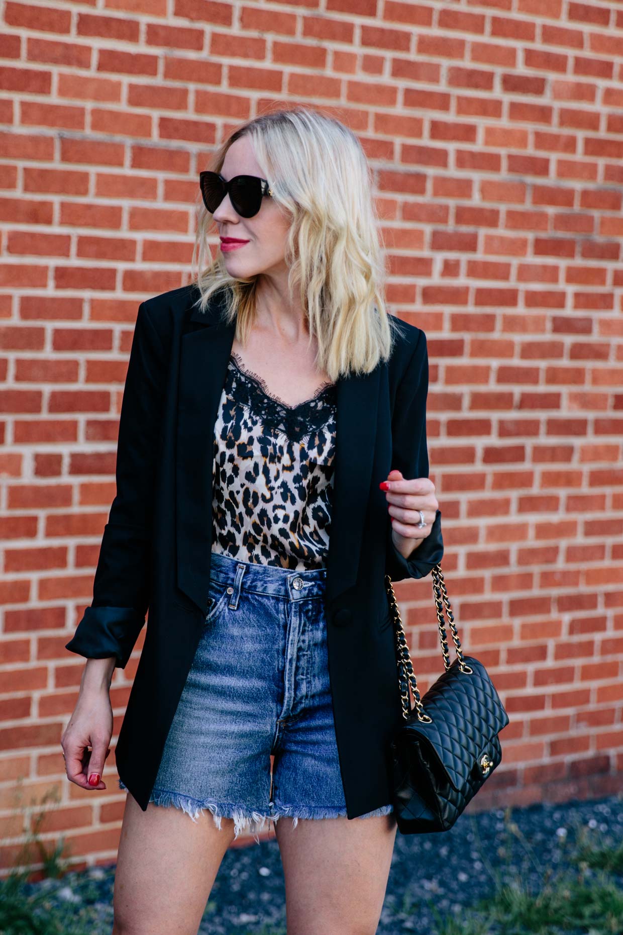 Meagan Brandon fashion blogger of Meagan's Moda shows leopard print  camisole outfit with black fluted midi skirt and red Saint Laurent high  school satchel - Meagan's Moda