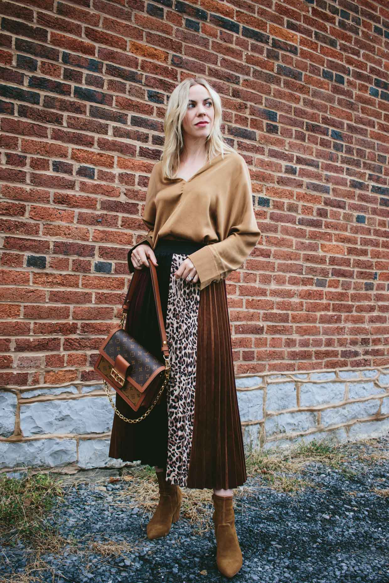 Meagan Brandon fashion blogger of Meagan's Moda wears H&M rust brown silk  shirt with leopard print pleated skirt, brown suede booties and Louis  Vuitton Dauphine bag for chic fall outfit - Meagan's