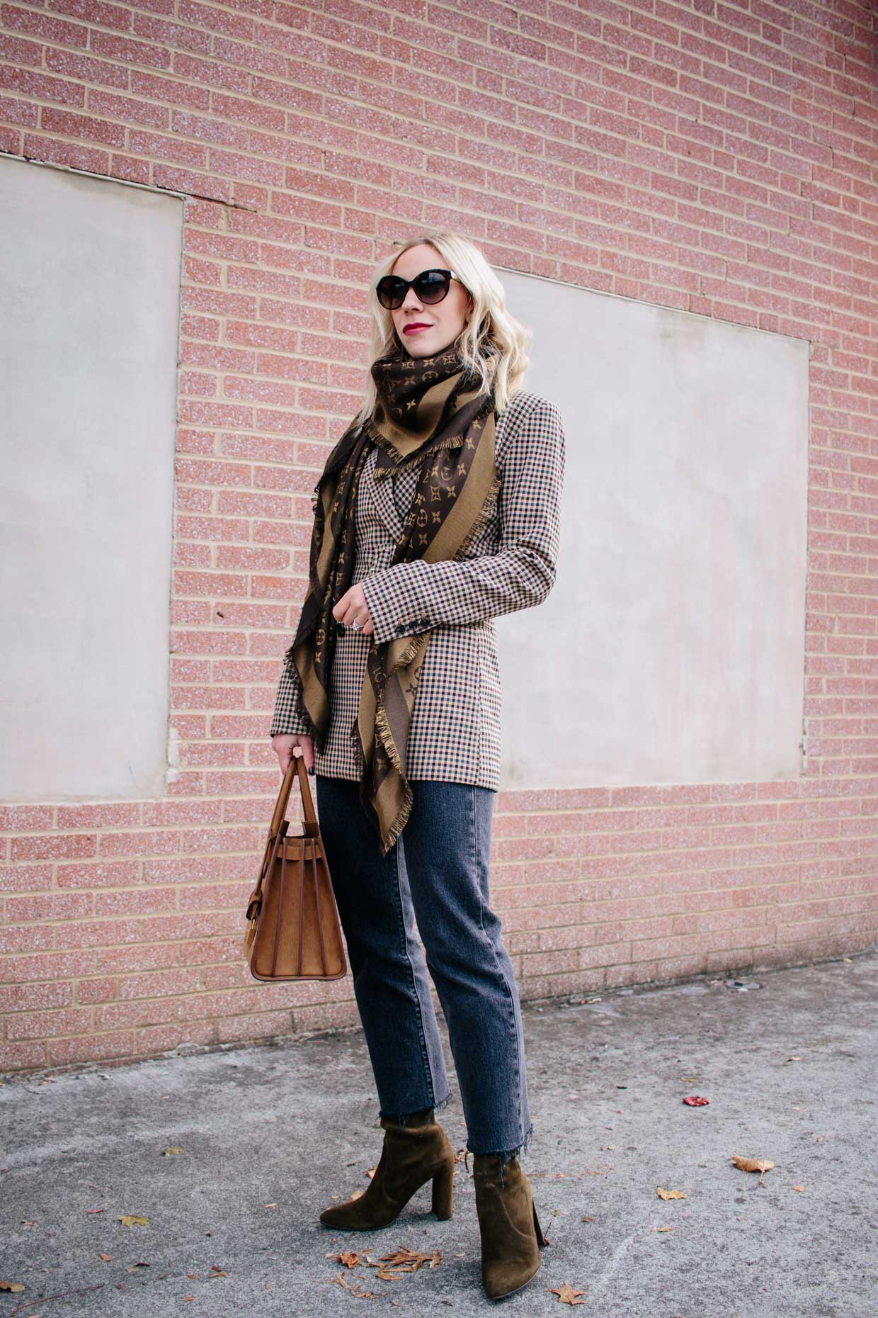 Meagan Brandon fashion blogger of Meagan's Moda wears H&M belted plaid  blazer with Louis Vuitton monogram scarf, Levi's wedgie jeans and sock boots  - Meagan's Moda
