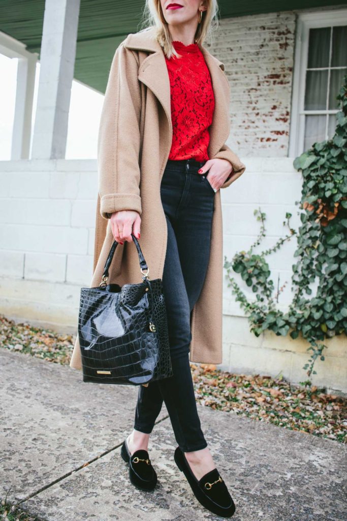 Meagan Brandon fashion blogger of Meagan's Moda wears camel coat with red lace blouse and black jeans, Gucci velvet loafers