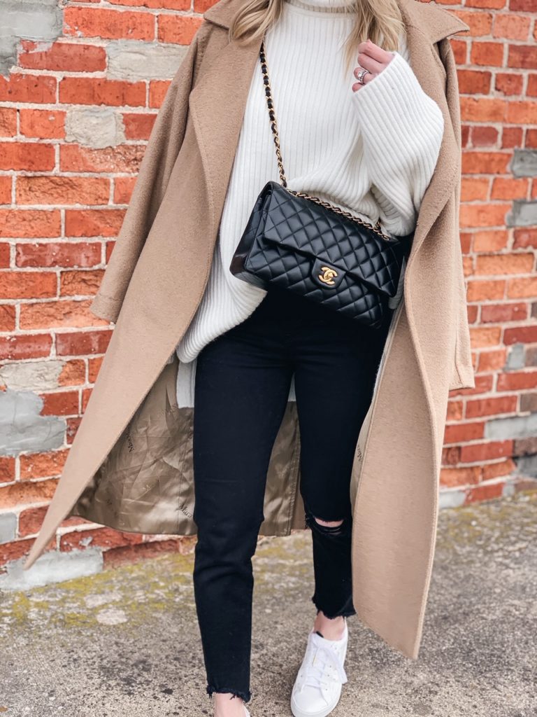 Meagan Brandon fashion blogger of Meagan's Moda wears camel coat with white turtleneck, black jeans and Chanel classic flap bag