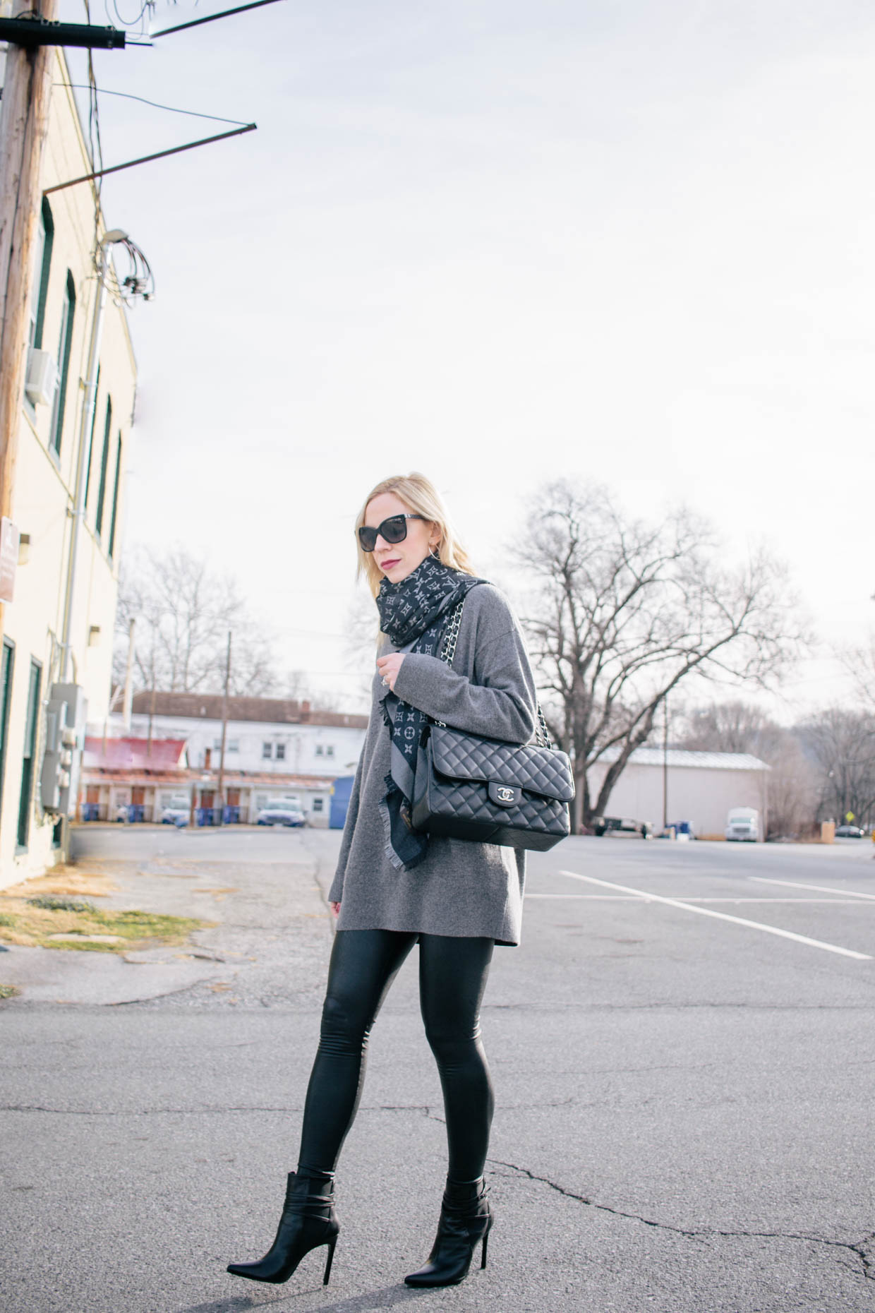 Meagan Brandon fashion blogger of Meagan's Moda wears Louis Vuitton black shine  shawl with black leather jacket and gray jeans, how to style a Louis Vuitton  shawl scarf - Meagan's Moda